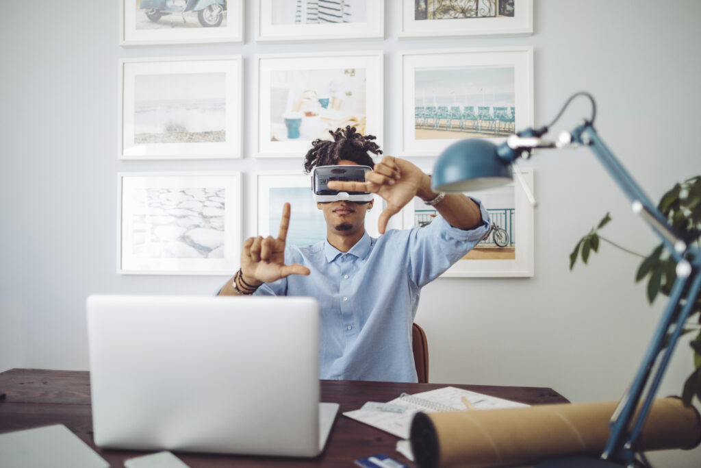 Young man at home with VR goggles on